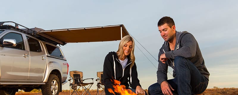 couple sitting at fire near 4wd with canopy - Offroad 4x4 accessories