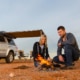 couple sitting at fire near 4wd with canopy - Offroad 4x4 accessories